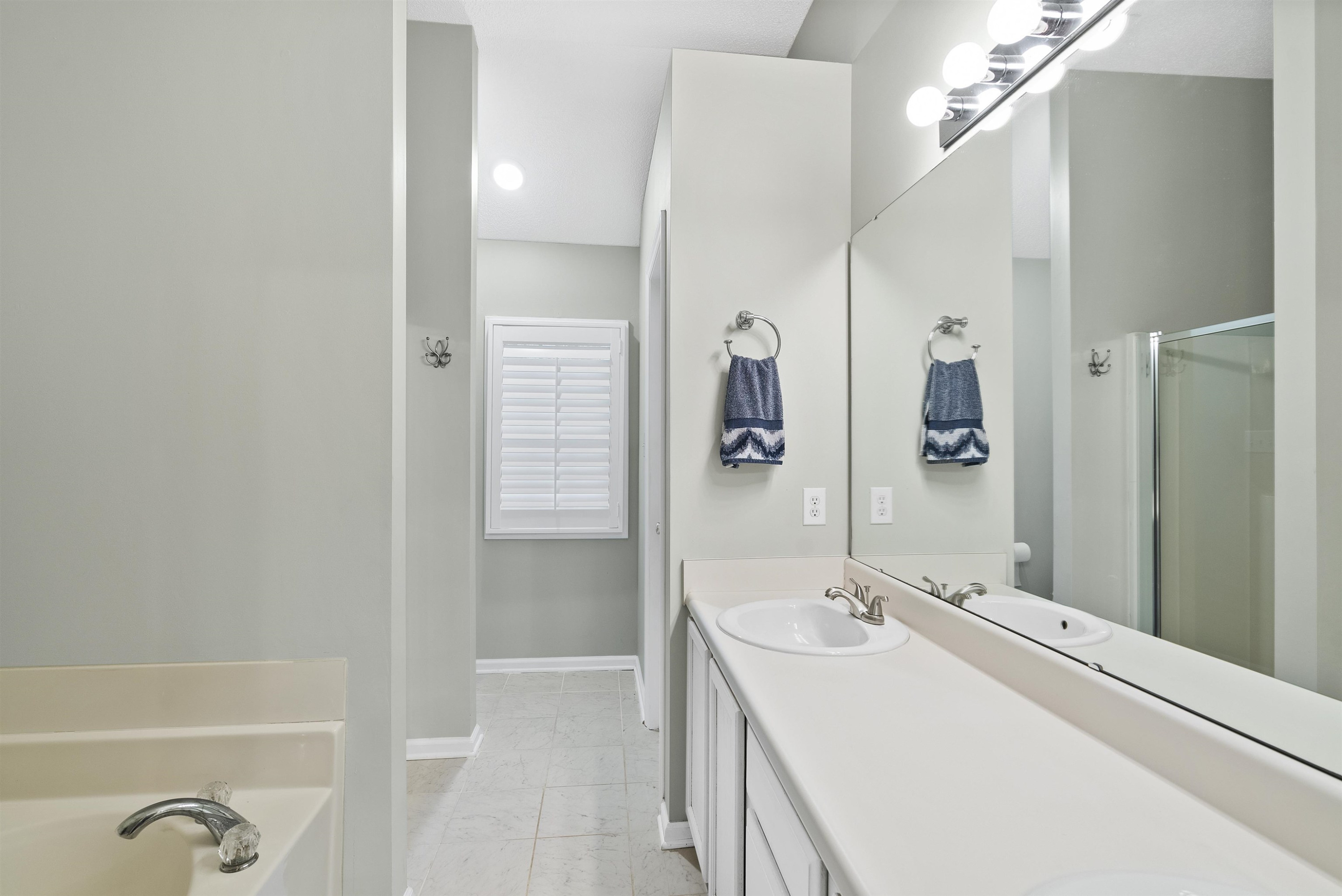 408 Chancellors Ridge Drive Durham, NC 27713 - Photo 26 of 34 a bathroom with a sink a mirror and a shower
