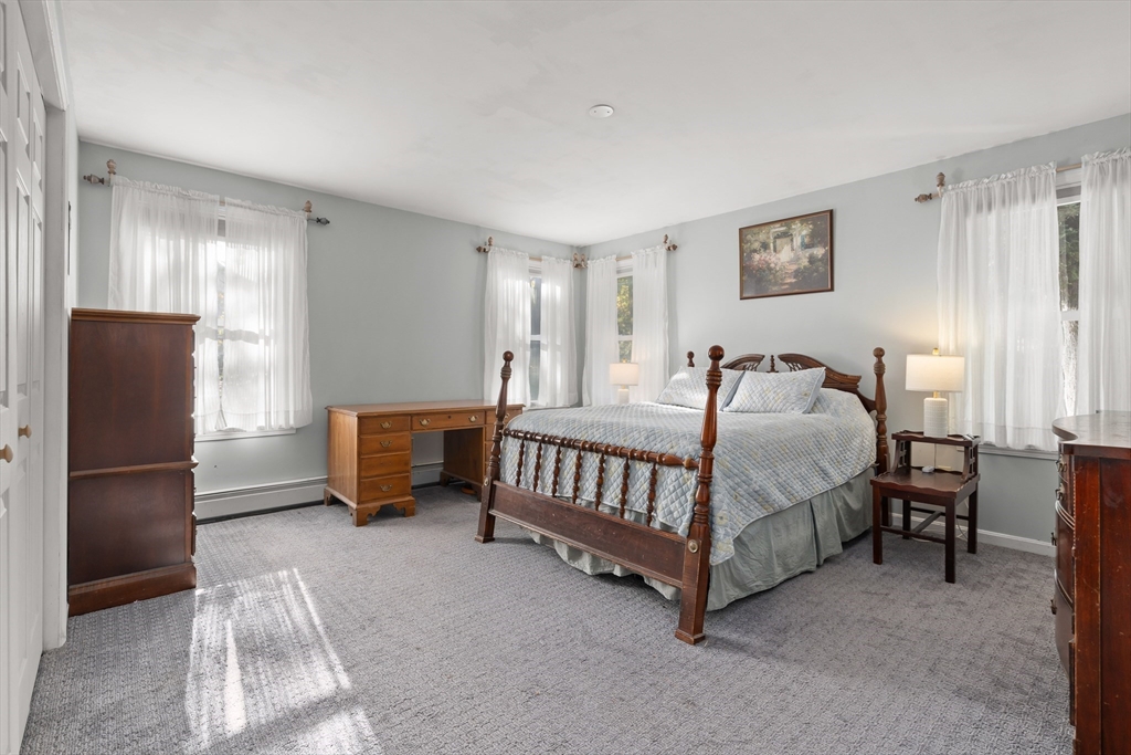 21 Francis Avenue Groveland, MA 01834 - Photo 18 of 29 a bedroom with a bed and a refrigerator