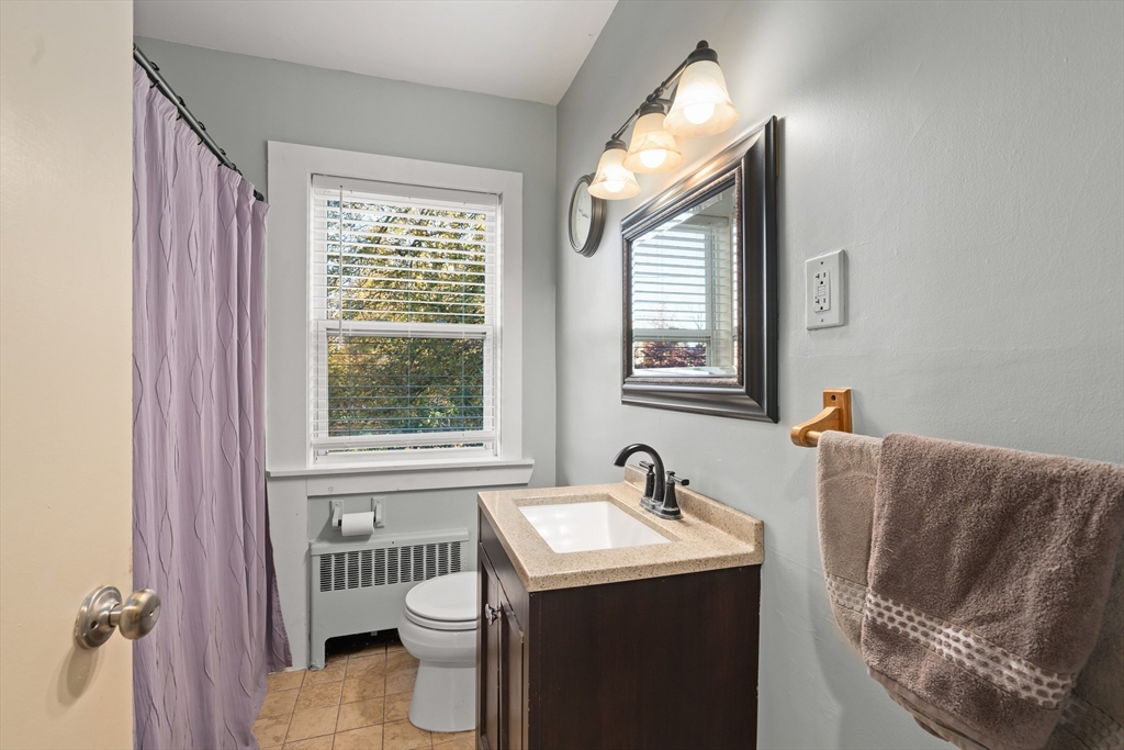21 Francis Avenue Groveland, MA 01834 - Photo 25 of 29 a bathroom with a sink and mirror with toilet