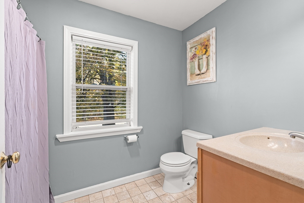 21 Francis Avenue Groveland, MA 01834 - Photo 26 of 29 a white toilet sitting next to a bathroom sink