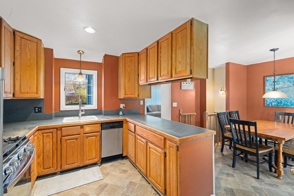 21 Francis Avenue Groveland, MA 01834 - Photo 7 of 29 a open kitchen with stainless steel appliances granite countertop a sink and a refrigerator