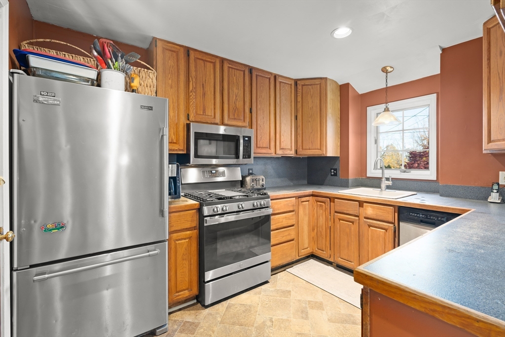 21 Francis Avenue Groveland, MA 01834 - Photo 8 of 29 a kitchen with stainless steel appliances granite countertop a refrigerator sink and stove