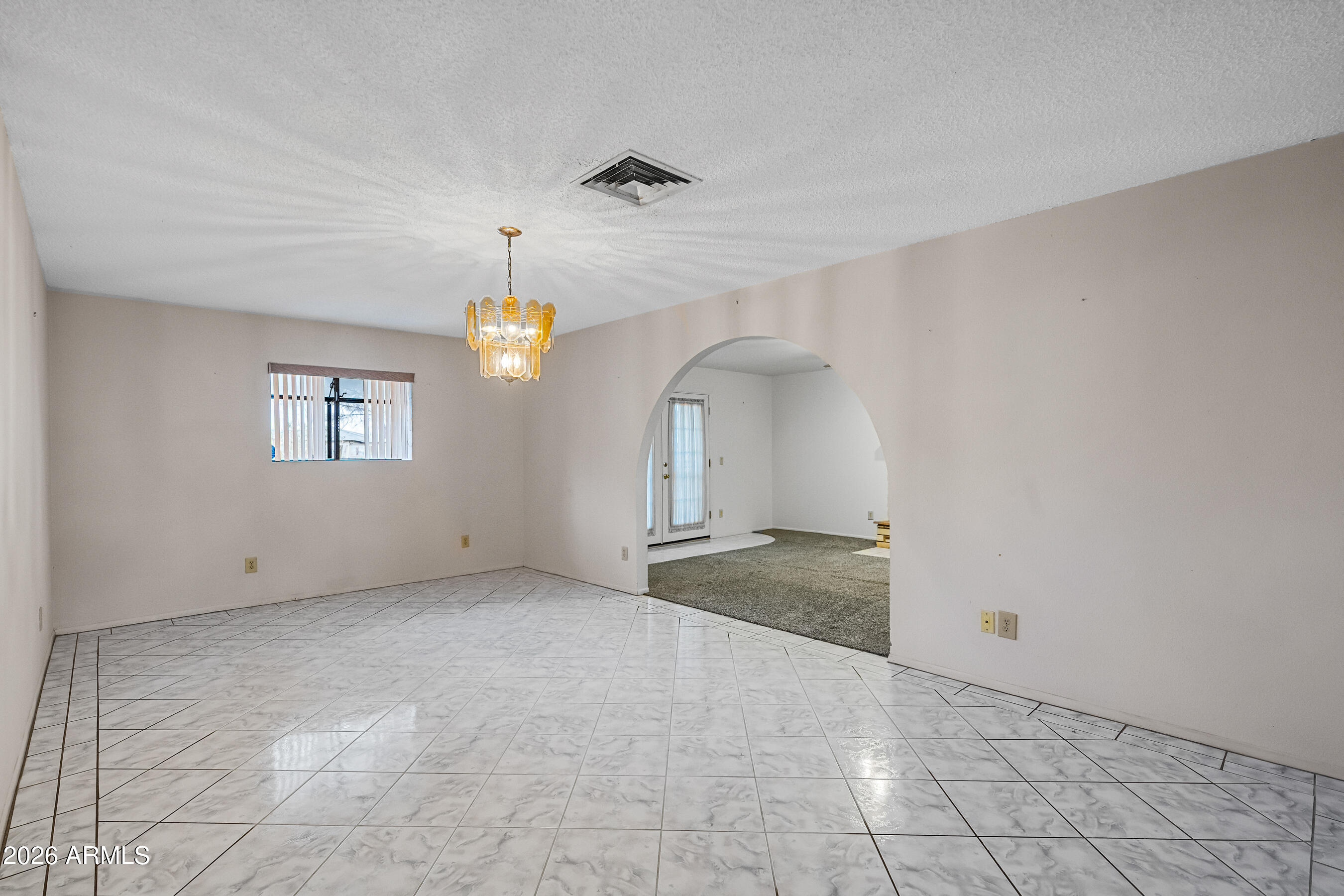 7358 Alamo Way Globe, AZ 85501 - Photo 11 of 68 an empty room with chandelier fan and windows