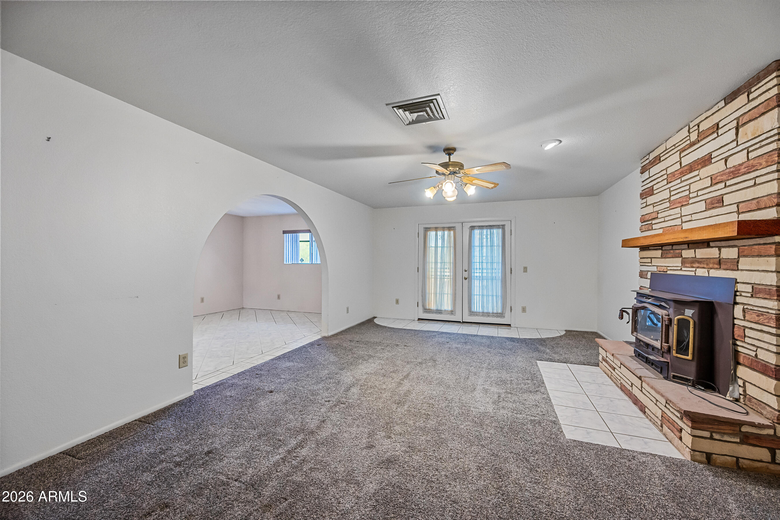 7358 Alamo Way Globe, AZ 85501 - Photo 15 of 68 an empty room with windows and fireplace