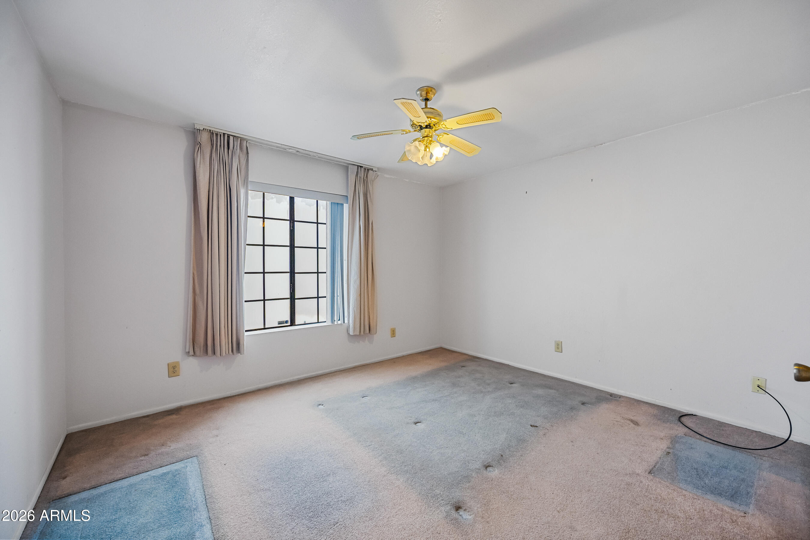7358 Alamo Way Globe, AZ 85501 - Photo 39 of 68 an empty room with a window and ceiling fan