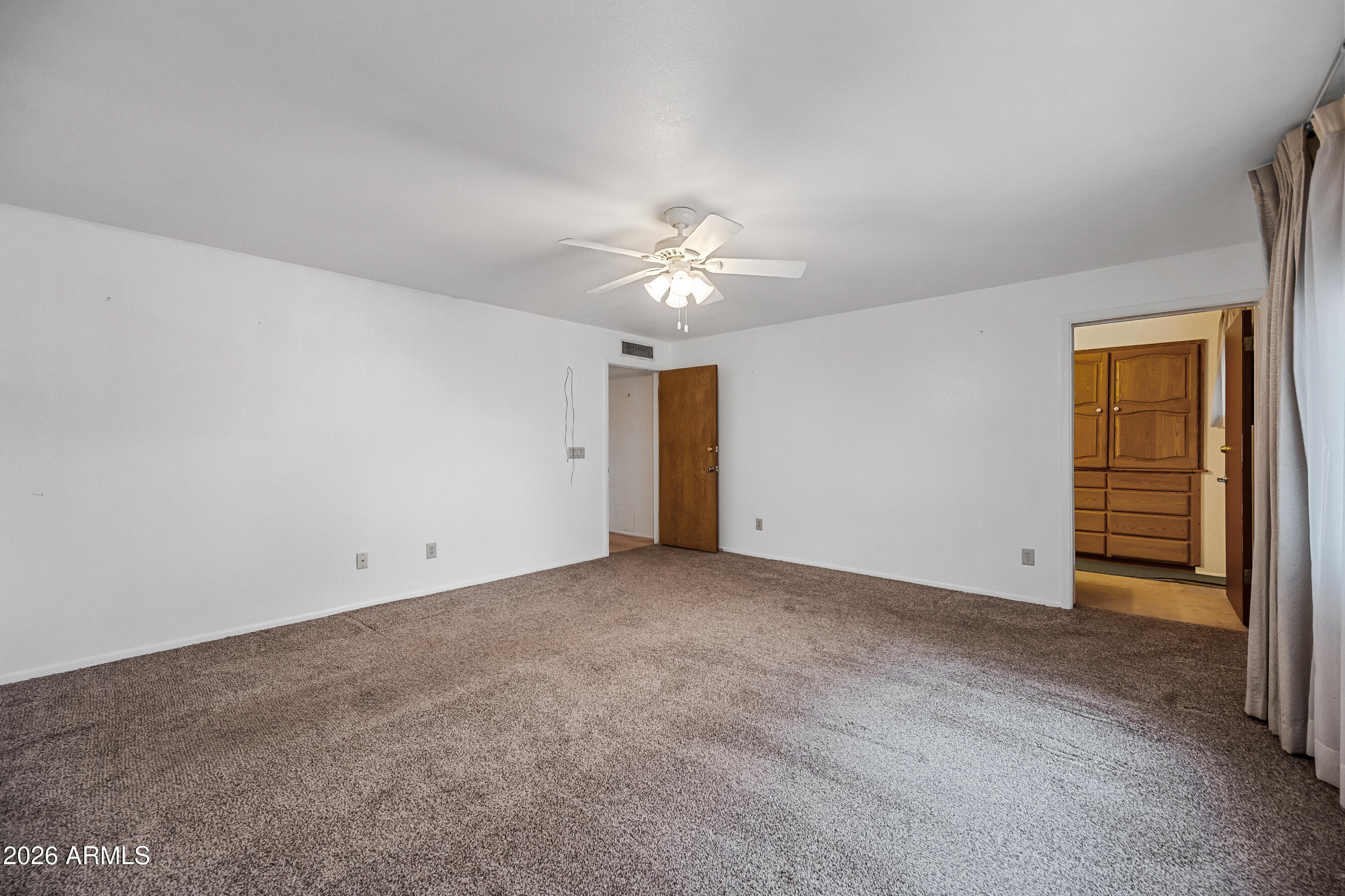 7358 Alamo Way Globe, AZ 85501 - Photo 41 of 68 an empty room with closet and a ceiling fan