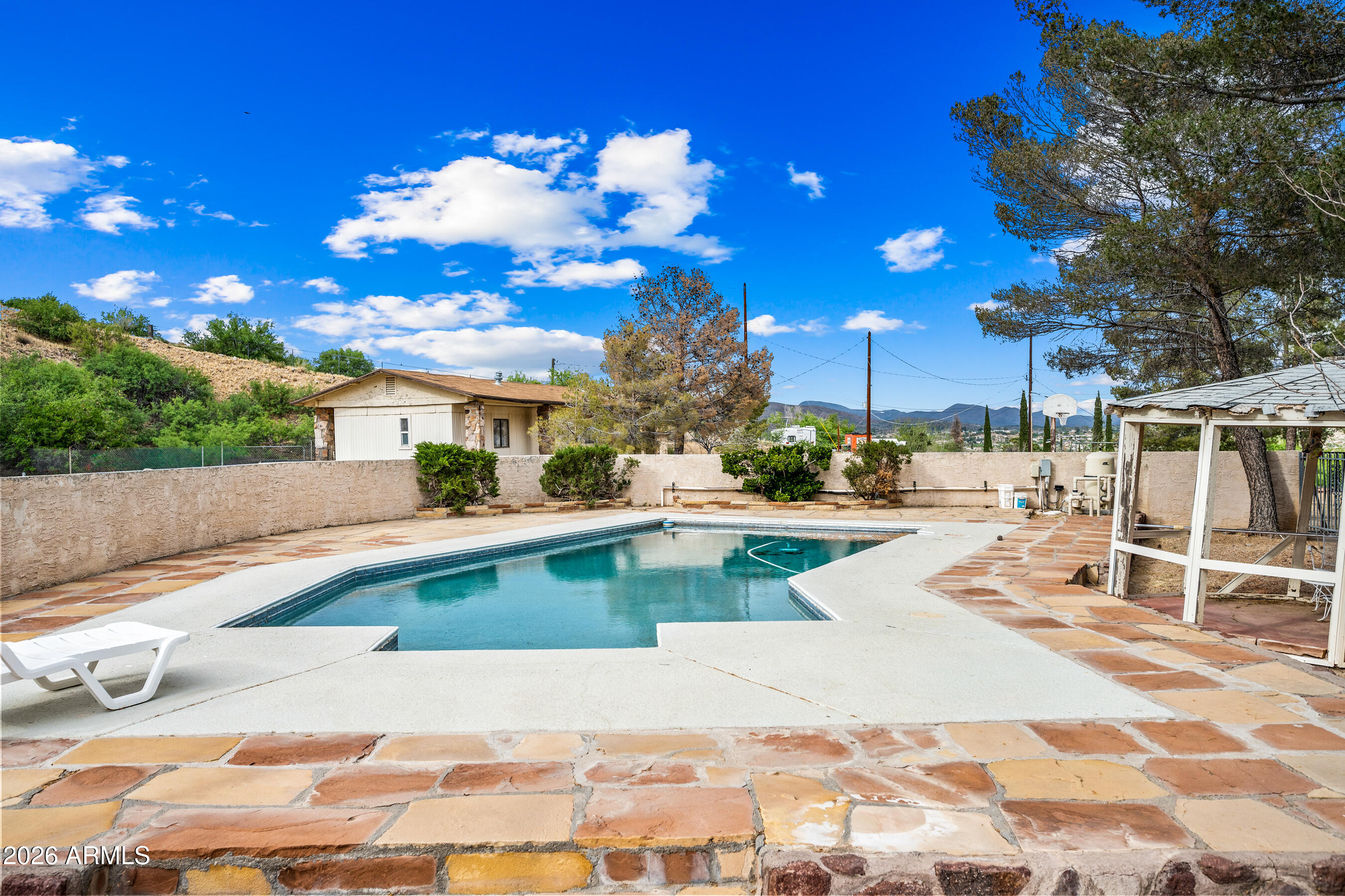 7358 Alamo Way Globe, AZ 85501 - Photo 5 of 68 a view of a swimming pool with a lounge chairs