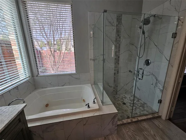 a bath tub sitting next to a shower