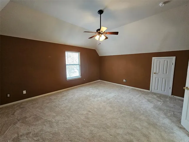 a view of a room with windows and ceiling fan