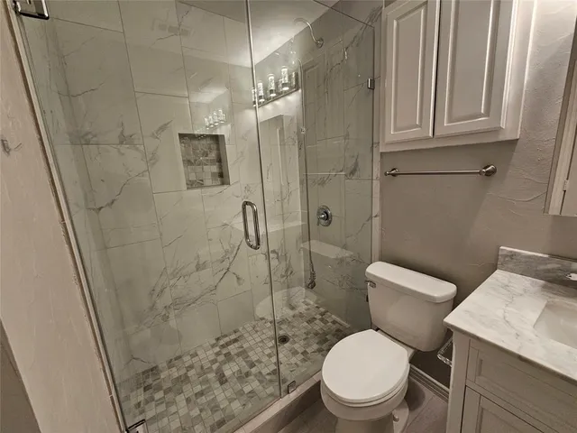 a white toilet sitting next to a bathroom sink