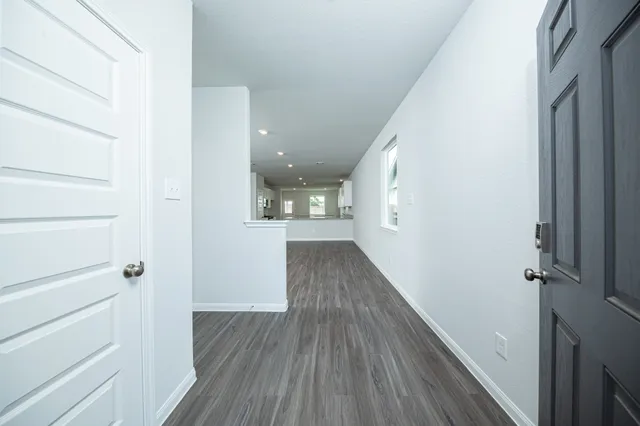 a view of hallway with wooden floor