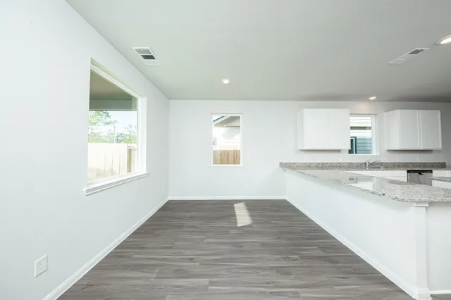 a view of a kitchen cabinets a sink and wooden floor