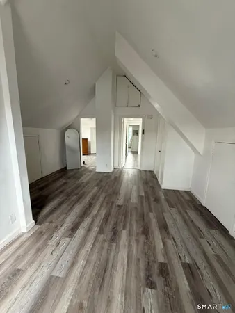 a view of a room with wooden floor