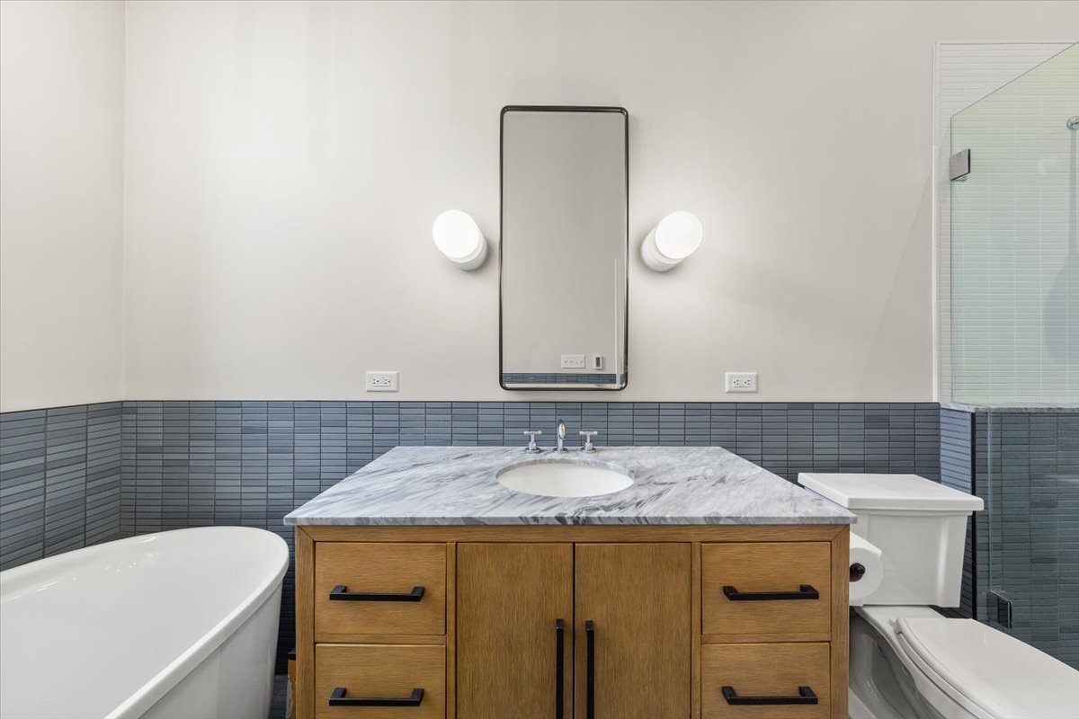 2849 North Burling Street, Unit 3 Chicago, IL 60657 - Photo 12 of 18 a bathroom with a sink and a mirror