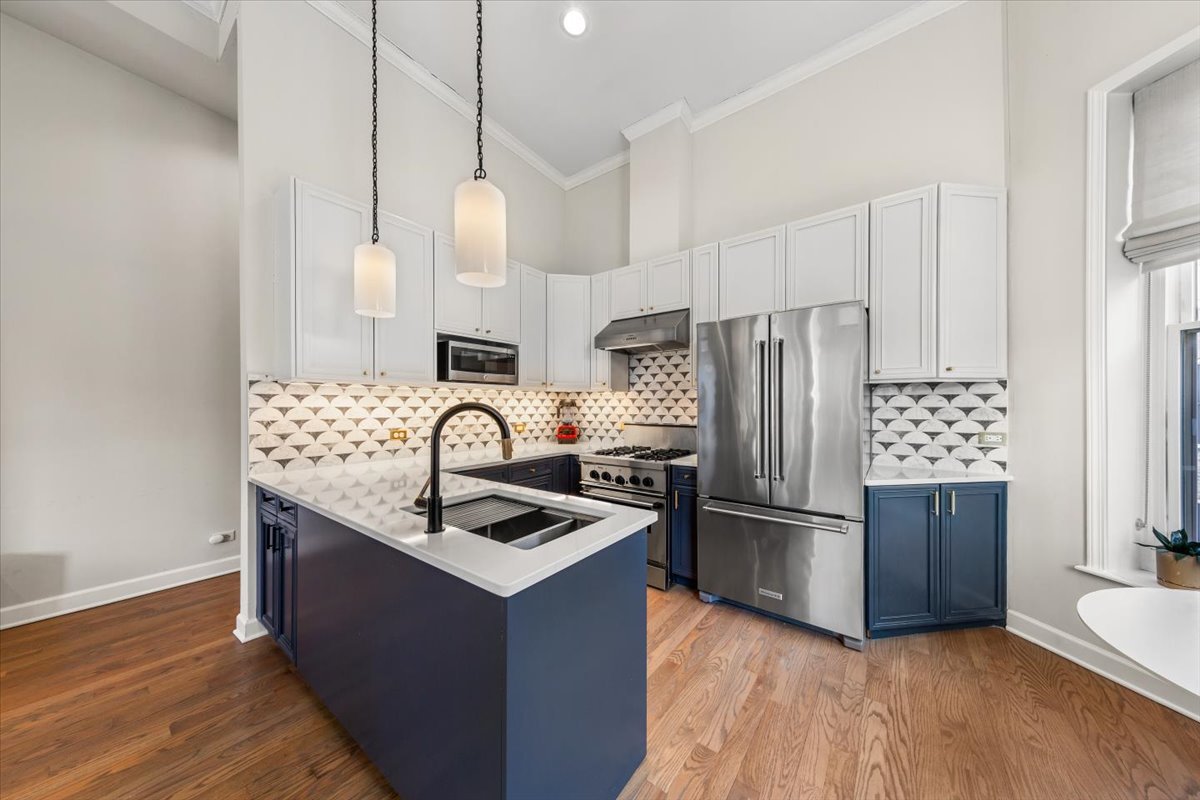 2849 North Burling Street, Unit 3 Chicago, IL 60657 - Photo 8 of 18 a kitchen with stainless steel appliances granite countertop a refrigerator a sink dishwasher a stove and white cabinets with wooden floor