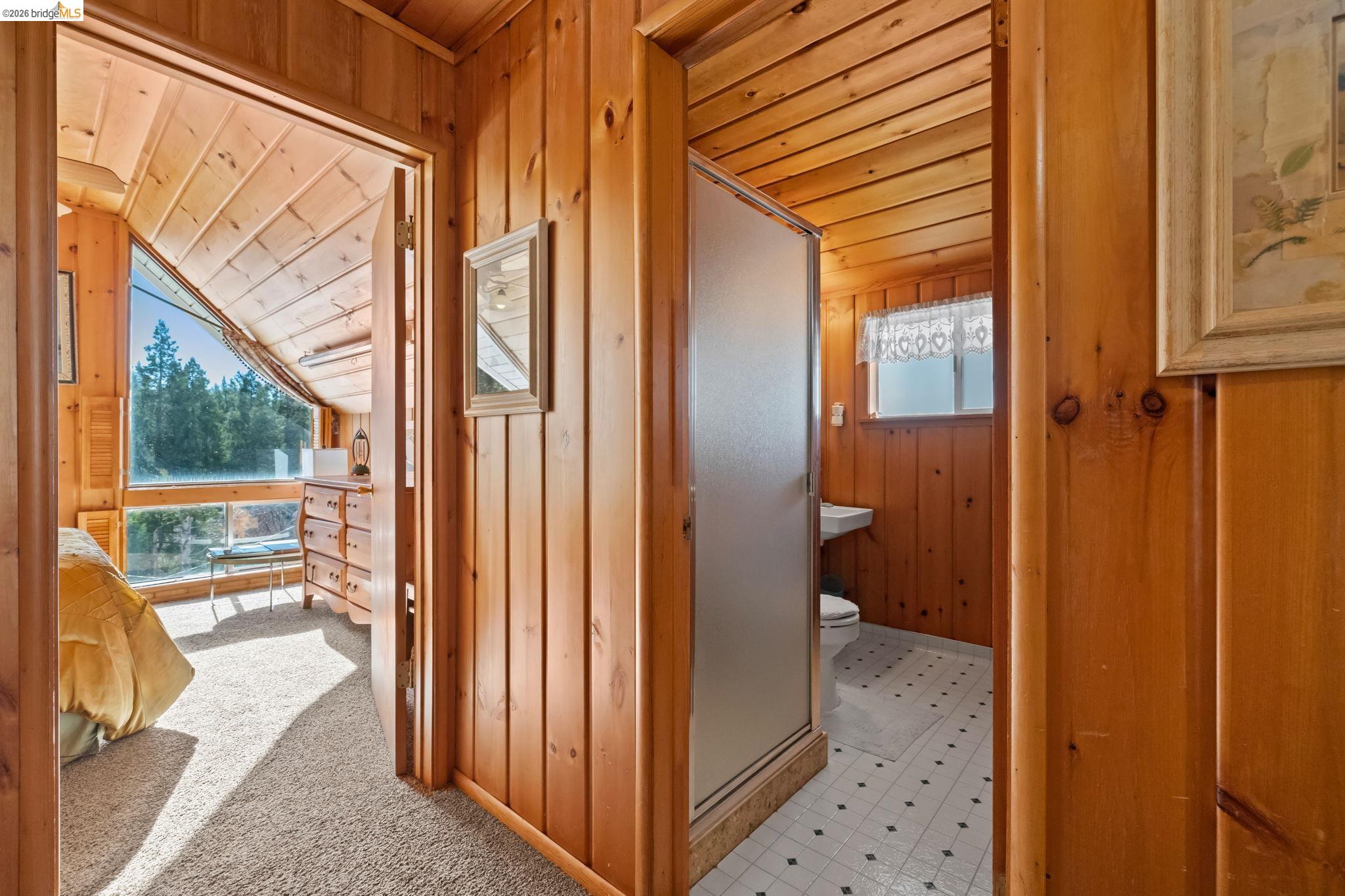 26039 Long Barn Road Long Barn, CA 95335 - Photo 21 of 27 Hall featuring wood ceiling, wooden walls, light flooring, light carpet, and lofted ceiling