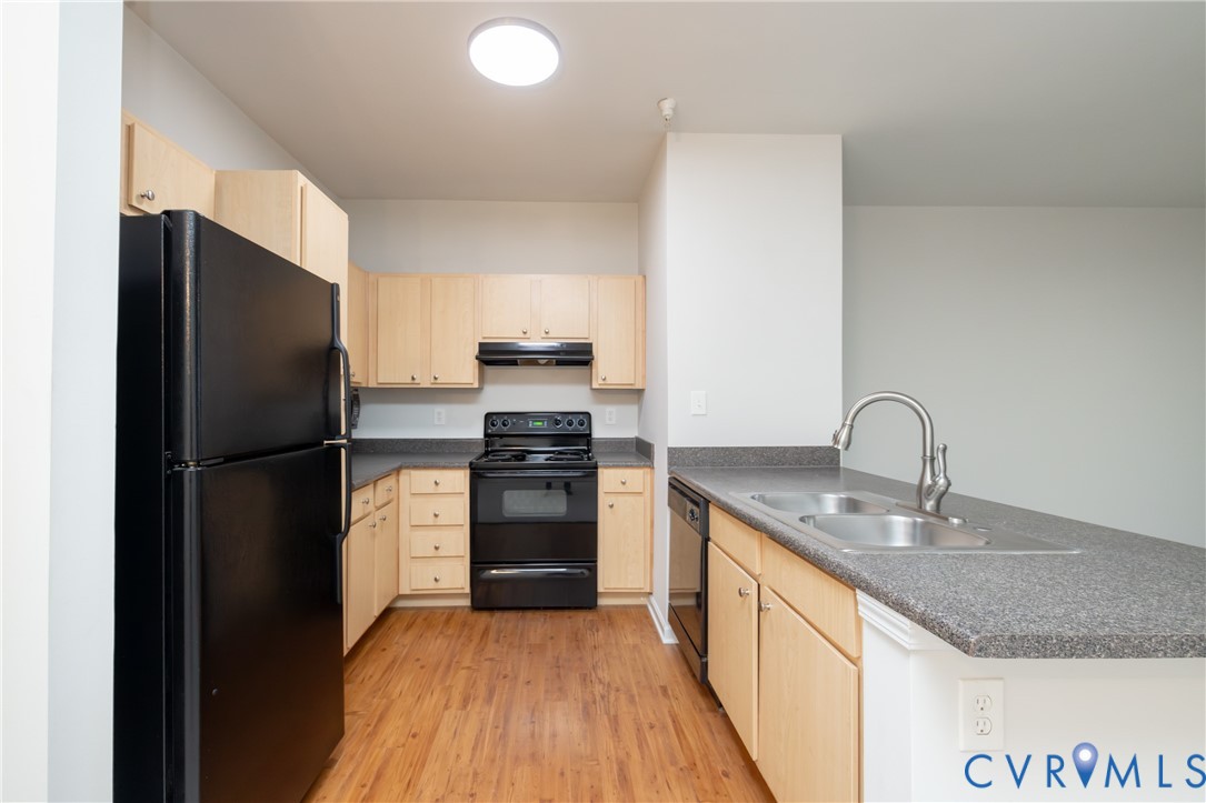 734 Bristol Village Drive, Unit 208 Midlothian, VA 23114 - Photo 11 of 24 a kitchen with granite countertop a refrigerator and a sink