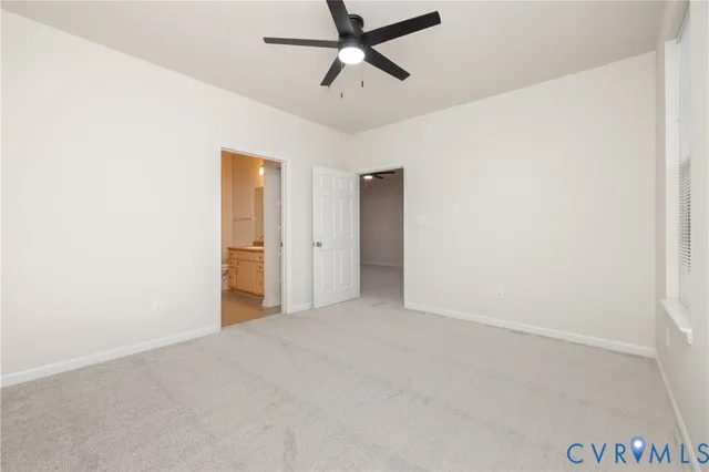 a view of a livingroom with a ceiling fan and window