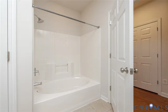 a white bath tub with shower