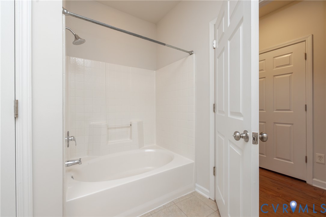 734 Bristol Village Drive, Unit 208 Midlothian, VA 23114 - Photo 22 of 24 a white bath tub with shower