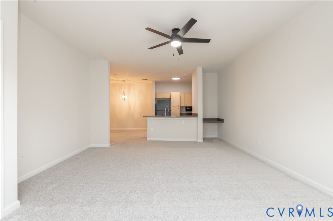 734 Bristol Village Drive, Unit 208 Midlothian, VA 23114 - Photo 7 of 24 a view of a livingroom with a ceiling fan and window