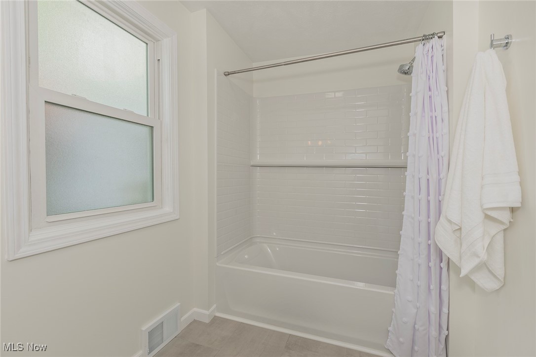 22275 Rye Road Beachwood, OH 44122 - Photo 31 of 39 Bathroom with shower / bath combo, wood finished floors, and baseboards