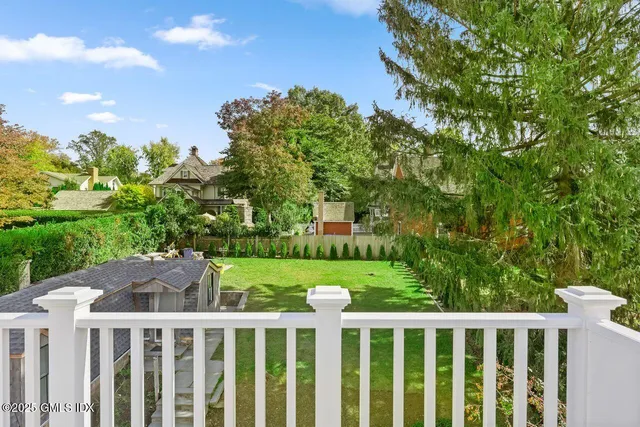 a view of a wooden fence and trees