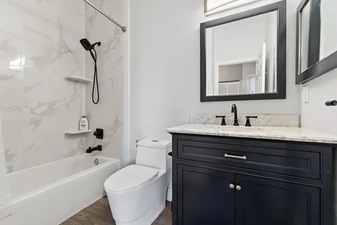 a bathroom with a sink a toilet and bathtub