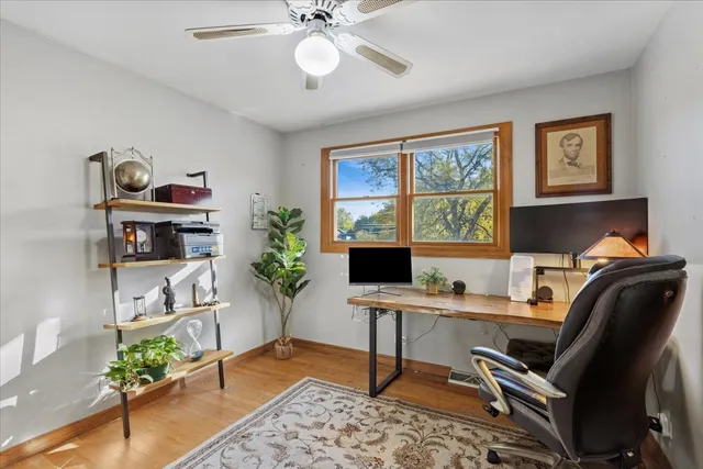 a view of a workspace with furniture and a potted plant