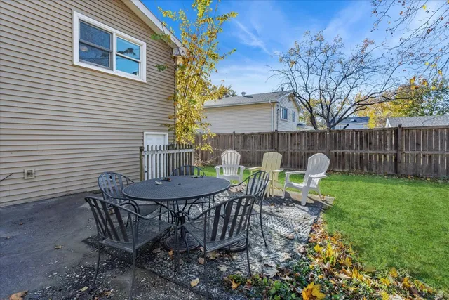 a view of a house with backyard and sitting area