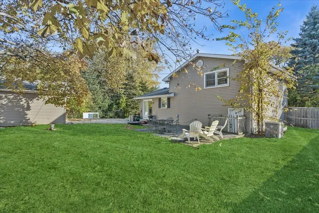 a front view of a house with garden and sitting area