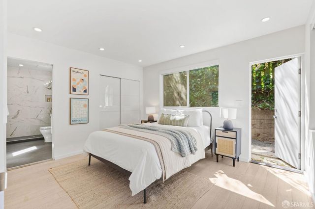 a bathroom with a double vanity sink toilet mirror and shower