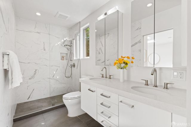 a bedroom with a bed and glass door