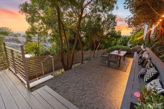 a backyard of a house with lots of plants and trees