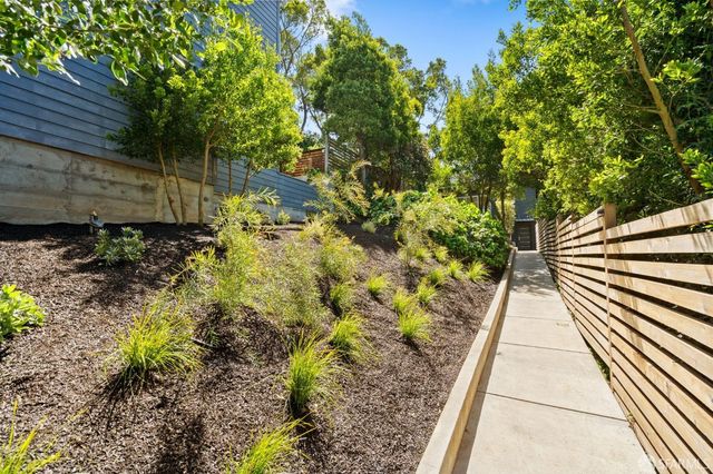 a view of a patio with couches table and chairs and potted plants