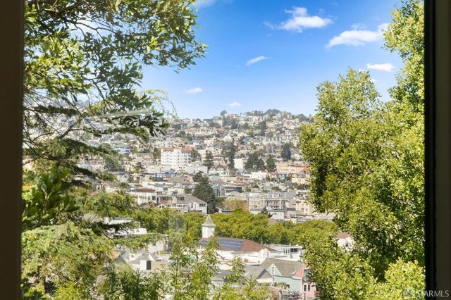 an aerial view of a house with a yard and a garden