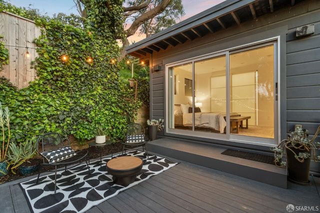 a bed sitting in a spacious bedroom next to a window