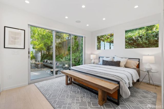 a bedroom with a bed and a large window