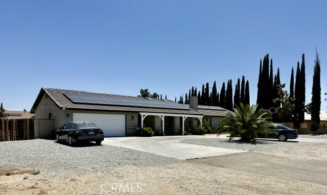 13375 Rincon Road Apple Valley, CA 92308 - Photo 6 of 72 a front view of a house with a yard and garage