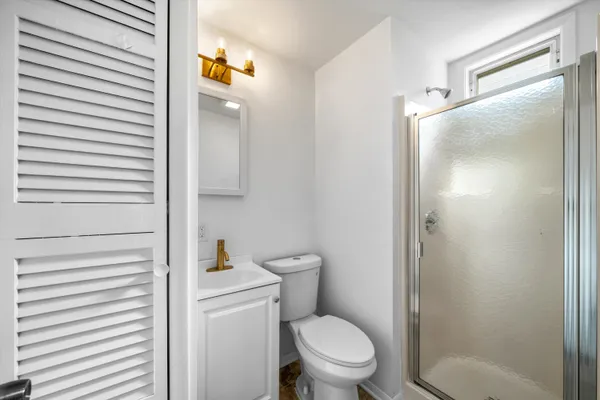 a white toilet sitting next to a bathroom sink