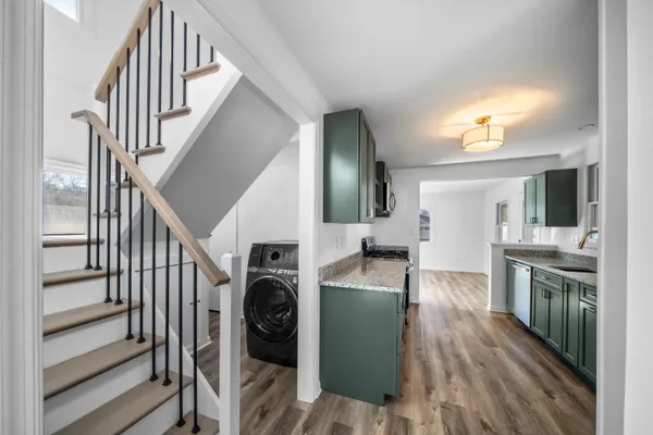 a view of a kitchen and an entryway with a kitchen
