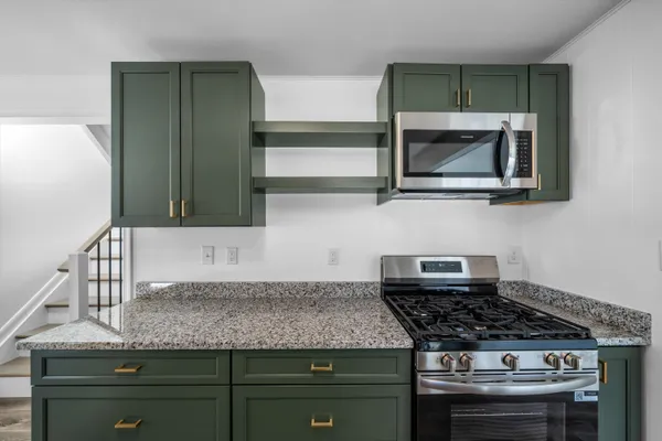 a kitchen with granite countertop stainless steel appliances and cabinets
