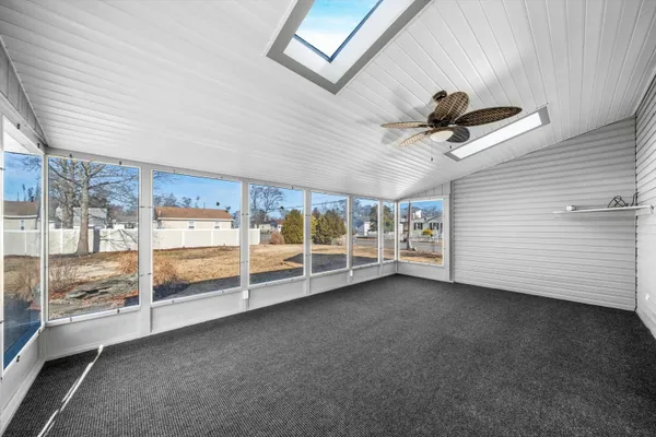 a view of a livingroom with a ceiling fan and window