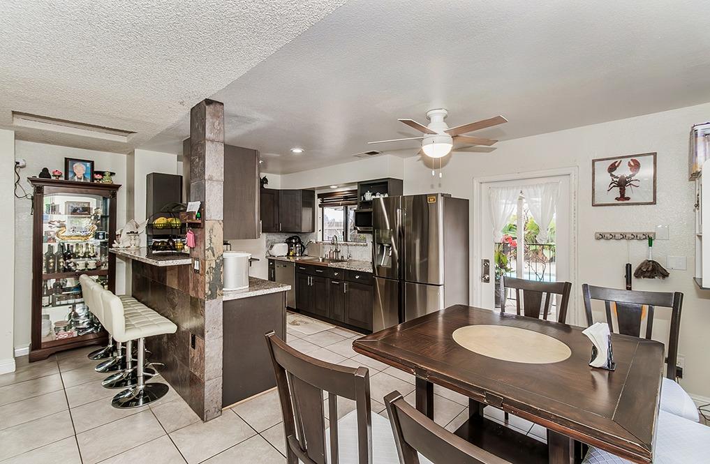 3012 Stanford Avenue Clovis, CA 93611 - Photo 11 of 41 a kitchen with a dining table and chairs