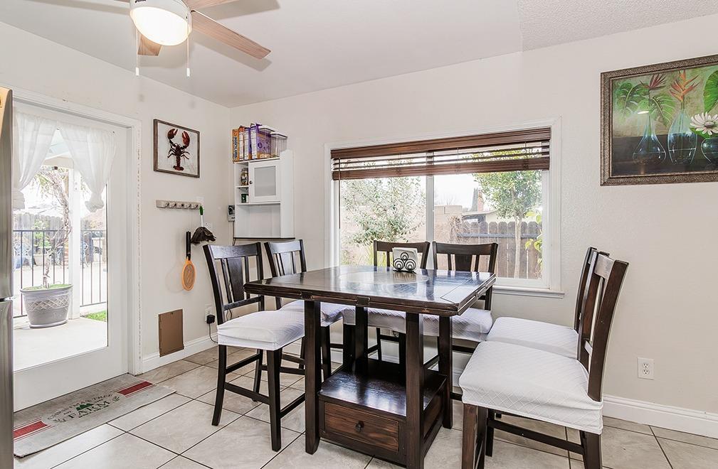 3012 Stanford Avenue Clovis, CA 93611 - Photo 12 of 41 a view of a dining room with furniture large window and wooden floor