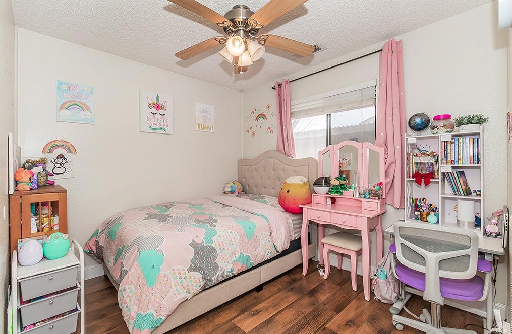 3012 Stanford Avenue Clovis, CA 93611 - Photo 19 of 41 a bedroom with a bed table and a window