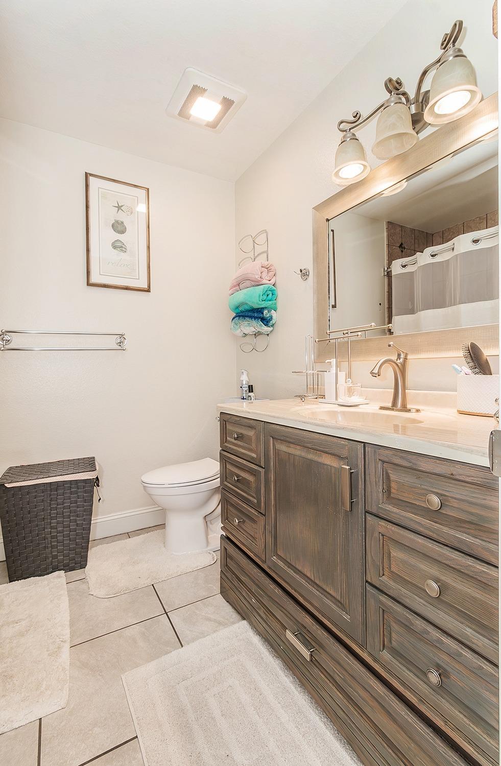 3012 Stanford Avenue Clovis, CA 93611 - Photo 20 of 41 a bathroom with a double vanity sink mirror and toilet