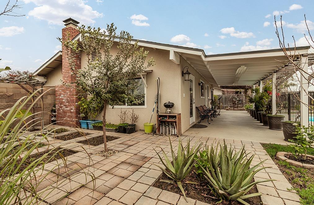 3012 Stanford Avenue Clovis, CA 93611 - Photo 26 of 41 a view of a patio with table and chairs with wooden floor and fence