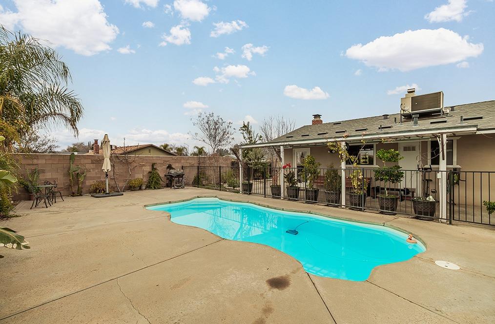 3012 Stanford Avenue Clovis, CA 93611 - Photo 4 of 41 a view of a swimming pool with a patio and a yard