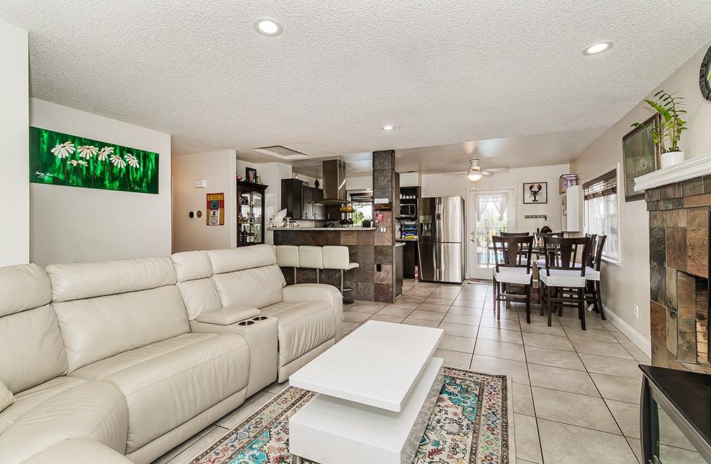 3012 Stanford Avenue Clovis, CA 93611 - Photo 9 of 41 a living room with furniture and a dining table with kitchen view